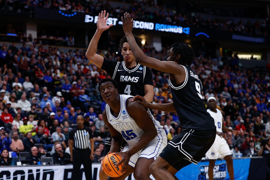 Mar 20, 2025; Denver, CO, USA; VCU Rams forward Jack Clark (4) and forward Luke Bamgboye (9) defend against Brigham Young Cougars center Fousseyni Traore (45) during the second half in the first round of the NCAA Tournament at Ball Arena. Mandatory Credit: Isaiah J. Downing-Imagn Images