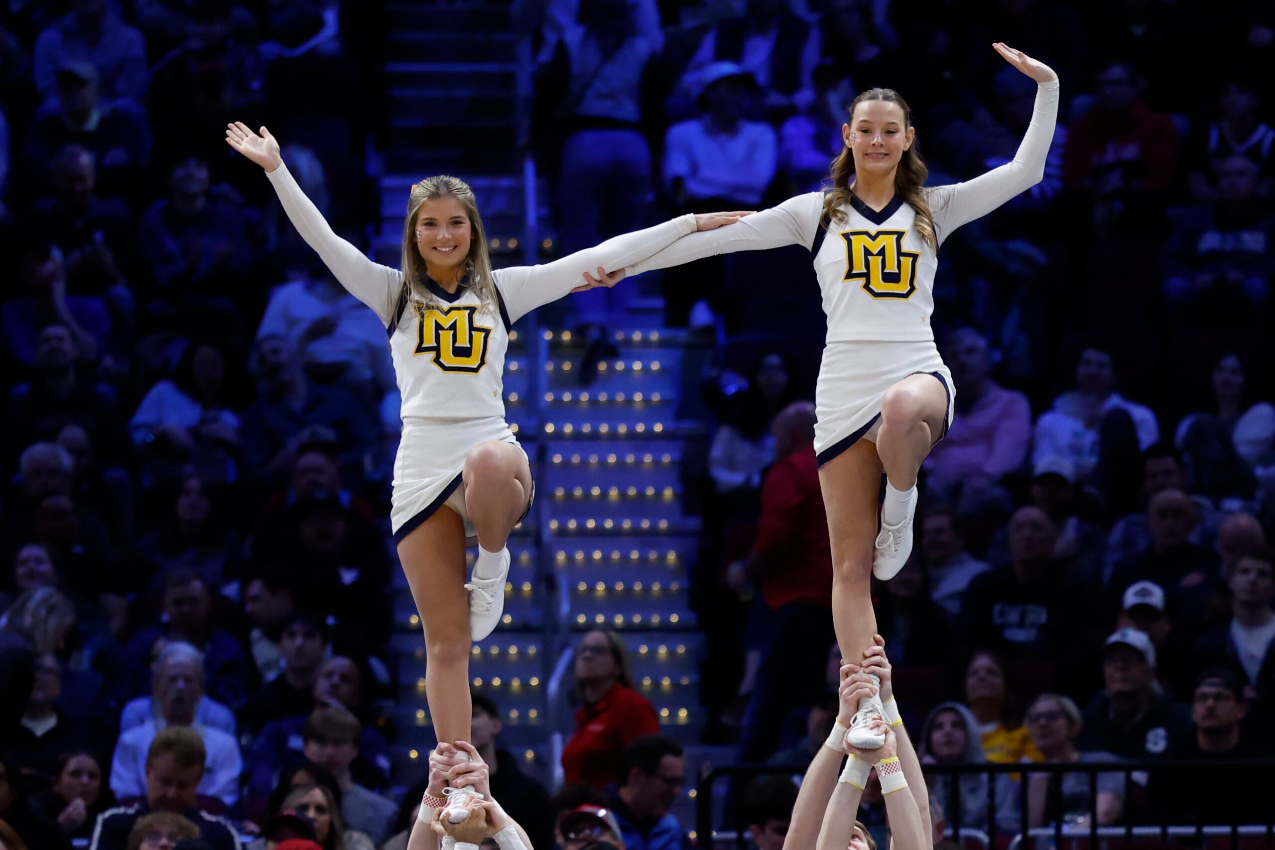 Mar 21, 2025; Cleveland, OH, USA; Marquette Golden Eagles cheerleaders perform in the first half against the New Mexico Lobos during the NCAA Tournament First Round at Rocket Arena. Mandatory Credit: Rick Osentoski-Imagn Images