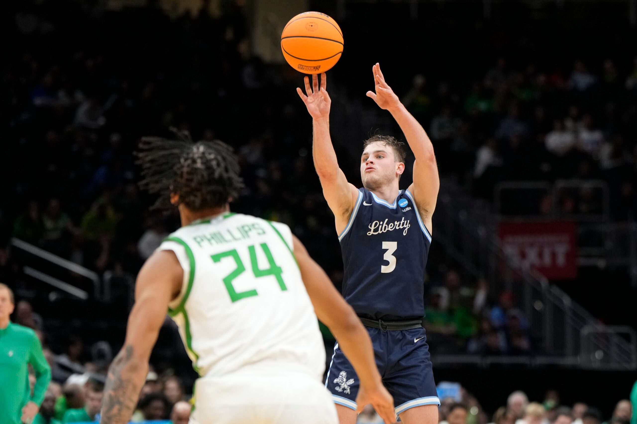 Mar 21, 2025; Seattle, WA, USA; Liberty Flames guard Kaden Metheny (3) shoots the ball against Oregon Ducks guard Jamari Phillips (24) during the second half in the first round of the NCAA Tournament  at Climate Pledge Arena. Mandatory Credit: Stephen Brashear-Imagn Images
