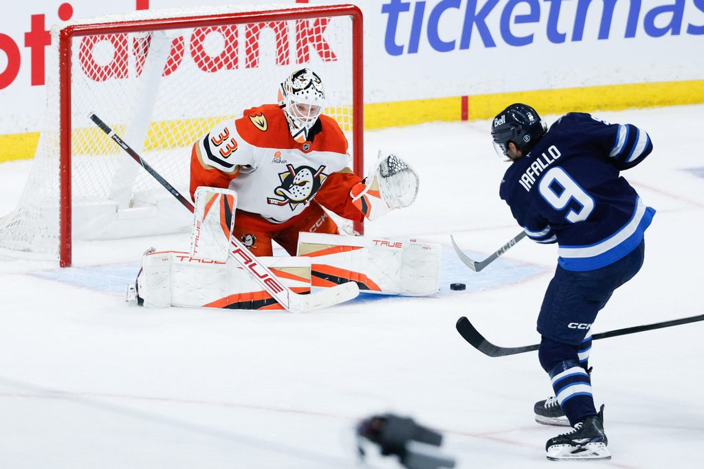 Apr 16, 2025; Winnipeg, Manitoba, CAN; Winnipeg Jets forward Alex Iafallo (9) takes a shot on Anaheim Ducks goalie Ville Husso (33) during the third period at Canada Life Centre. Mandatory Credit: Terrence Lee-Imagn Images