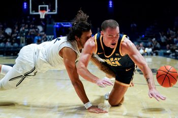 Xavier Musketeers forward Tre Carroll (12) and Murray State Racers guard Brayden Shorter (34) collide in the second half of a NCAA men’s basketball game between the Xavier Musketeers and Murray State Racers, Saturday, Oct. 18, 2025, at Cintas Center in Cincinnati. Racers won 75-70.
