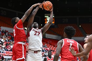 Oct 25, 2025; Pullman, WA, USA; Washington State Cougars forward Nd Okafor (22) is fouled on the shot by New Mexico Lobos guard Tajavis Miller (2) in the second half at Friel Court at Beasley Coliseum. Washington State Cougars won 74-66. Mandatory Credit: James Snook-Imagn Images