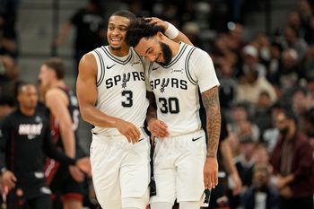 Oct 30, 2025; San Antonio, Texas, USA; San Antonio Spurs forward Keldon Johnson (3) and forward Julian Champagnie (30) react after the first quarter against the Miami Heat at Frost Bank Center. Mandatory Credit: Scott Wachter-Imagn Images