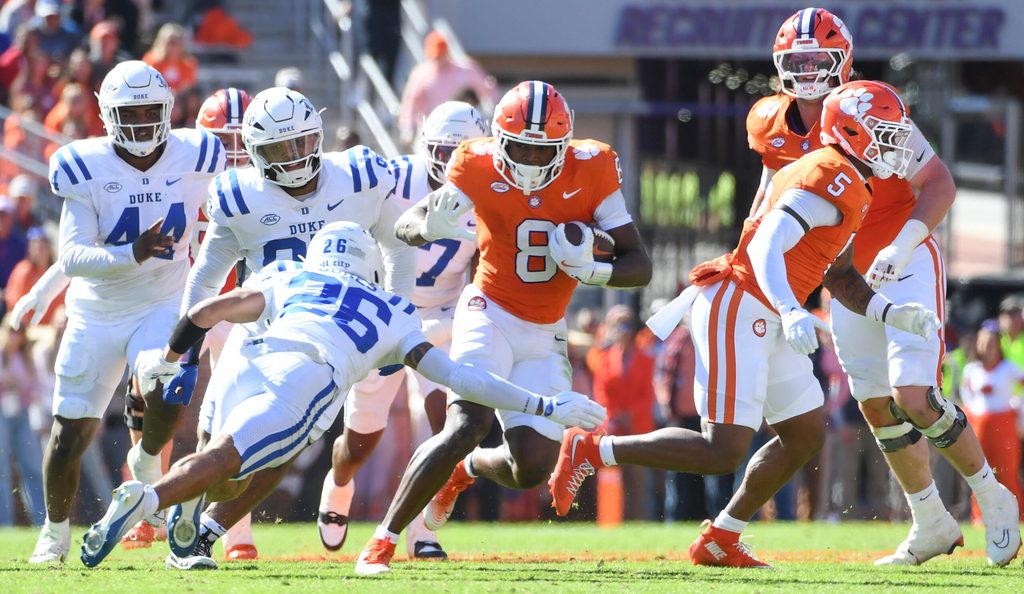 Nov 1, 2025; Clemson, South Carolina, USA; Duke Blue Devils safety Ma'Khi Jones (26) goes to tackle Clemson Tigers running back Adam Randall (8) during the game at Memorial Stadium. Mandatory Credit: Alex Martin-Imagn Images
