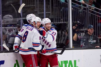Nov 1, 2025; Seattle, Washington, USA;  New York Rangers left wing Will Cuylle (50), New York Rangers defenseman Adam Fox (23), and New York Rangers center J.T. Miller (8) celebrate an overtime win against the Seattle Kraken at Climate Pledge Arena. Mandatory Credit: Blake Dahlin-Imagn Images