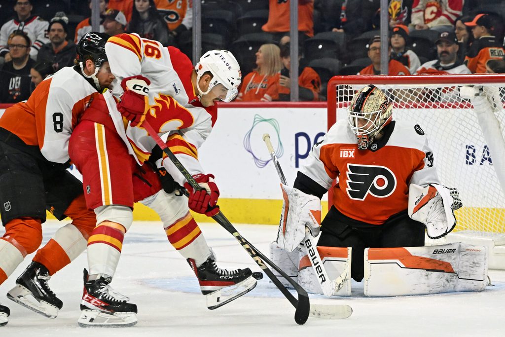 Nov 2, 2025; Philadelphia, Pennsylvania, USA; Philadelphia Flyers goaltender Aleksei Kolosov (35) makes a save agaijnst Calgary Flames center Morgan Frost (16) during the first period at Xfinity Mobile Arena. Mandatory Credit: Eric Hartline-Imagn Images
