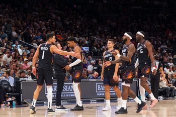 Nov 2, 2025; Phoenix, Arizona, USA; Phoenix Suns guard Devin Booker (1), forward Ryan Dunn (0), Coach Jordan Ott, guard Grayson Allen (8), forward Royce O'Neale (00) and center Mark Williams (15) celebrate during a time-out in the second half against the San Antonio Spurs at Mortgage Matchup Center. Mandatory Credit: Allan Henry-Imagn Images