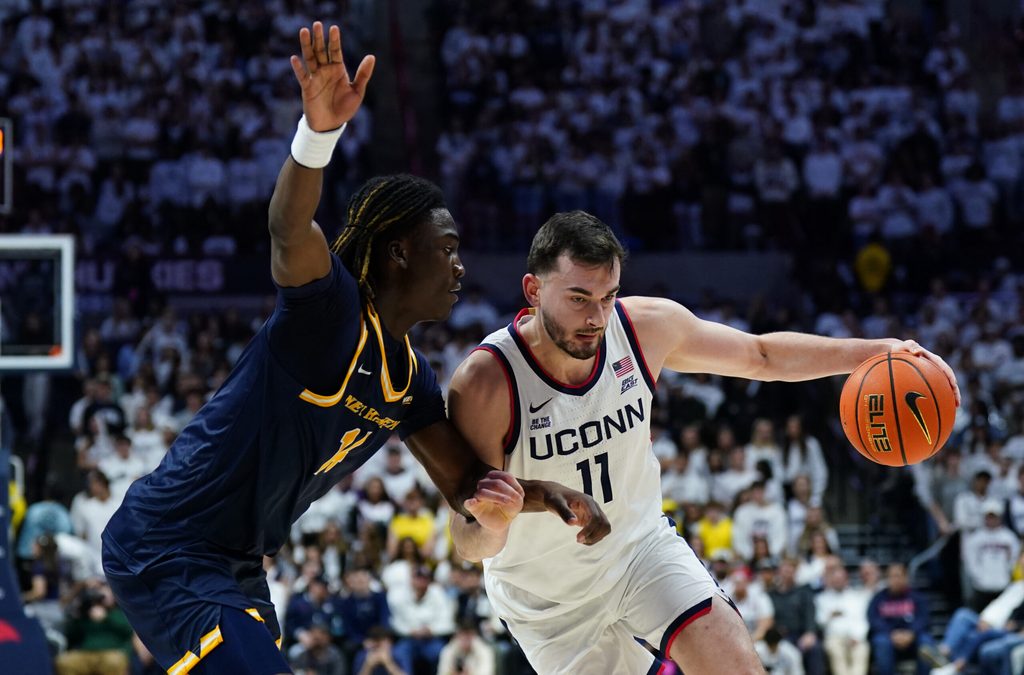Nov 3, 2025; Storrs, Connecticut, USA; UConn Huskies forward Alex Karaban (11) drives the ball against New Haven Chargers guard/forward Teshaun Steele (14) in the second half at Harry A. Gampel Pavilion. Mandatory Credit: David Butler II-Imagn Images