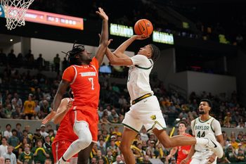 Nov 3, 2025; Waco, Texas, USA; Baylor Bears guard Cameron Carr (43) drives to the basket on UT Rio Grande Valley Vaqueros forward Kye Dickson (7) during the second half at Paul and Alejandra Foster Pavilion. Mandatory Credit: Raymond Carlin III-Imagn Images