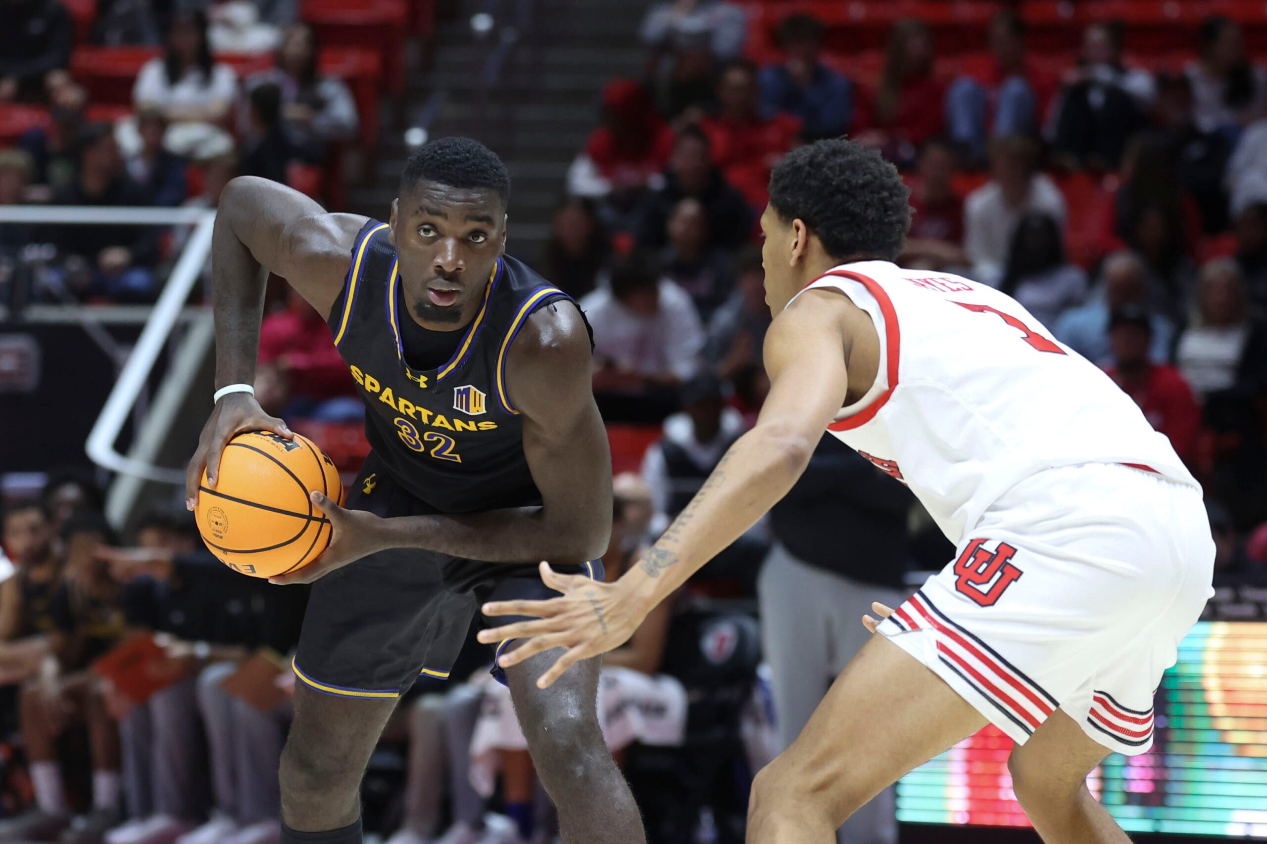 Nov 3, 2025; Salt Lake City, Utah, USA; San Jose State Spartans forward Yaphet Moundi (32) looks for a play against Utah Utes forward Josh Hayes (7) during the first half at Jon M. Huntsman Center. Mandatory Credit: Rob Gray-Imagn Images