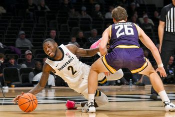 Nov 3, 2025; Nashville, Tennessee, USA;  Lipscomb Bisons forward Titas Sargiunas (26) fouls Vanderbilt Commodores guard Duke Miles (2) during the second half at Memorial Gymnasium. Mandatory Credit: Steve Roberts-Imagn Images