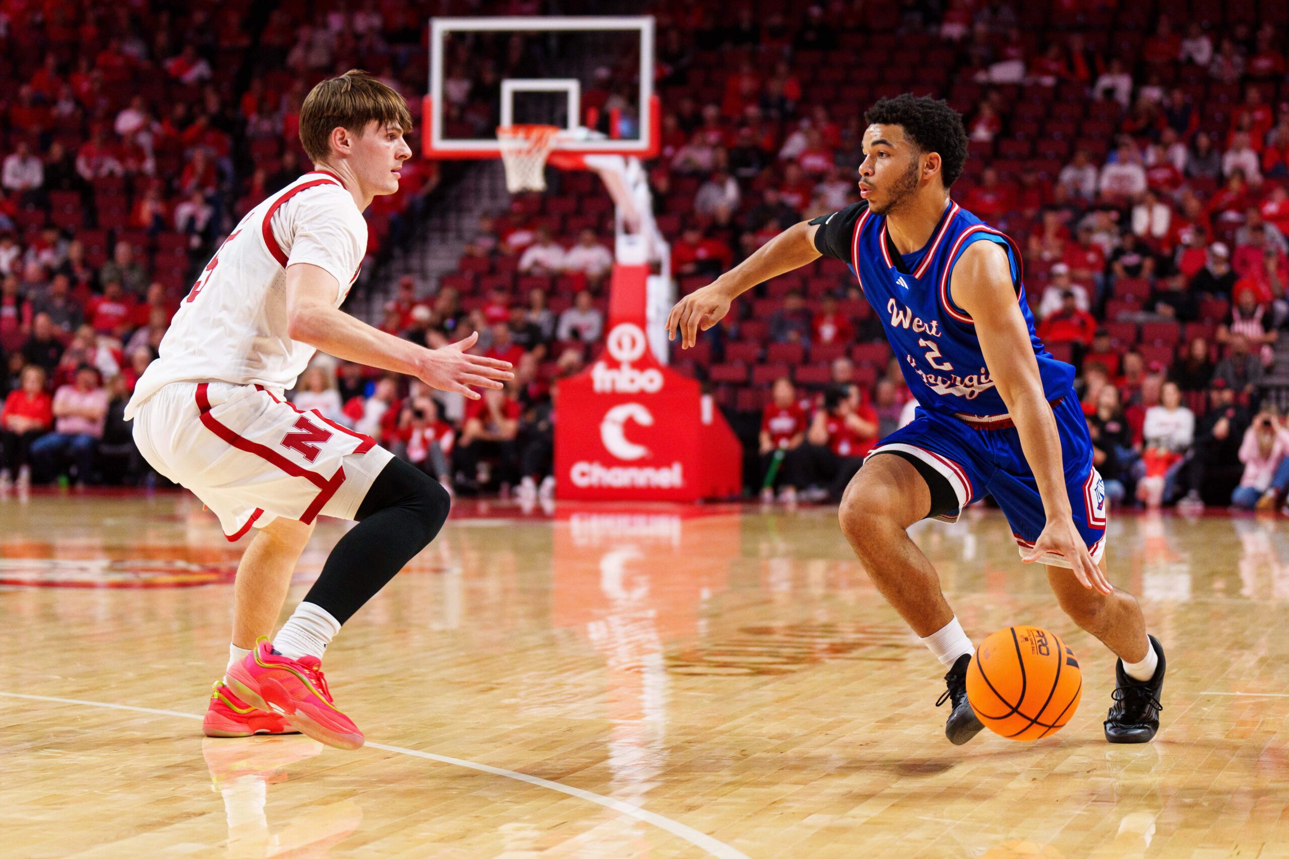 Nov 3, 2025; Lincoln, Nebraska, USA; West Georgia Wolves guard Chas Lewless (2) drives against Nebraska Cornhuskers forward Braden Frager (5) during the second half at Pinnacle Bank Arena. Mandatory Credit: Dylan Widger-Imagn Images