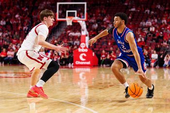 Nov 3, 2025; Lincoln, Nebraska, USA; West Georgia Wolves guard Chas Lewless (2) drives against Nebraska Cornhuskers forward Braden Frager (5) during the second half at Pinnacle Bank Arena. Mandatory Credit: Dylan Widger-Imagn Images