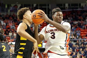 Nov 3, 2025; Auburn, Alabama, USA;  Auburn Tigers forward Keshawn Murphy (3) grabs a rebound over Bethune-Cookman Wildcats forward Daniel Rouzan (23) during the second half at Neville Arena.  Mandatory Credit: John Reed-Imagn Images