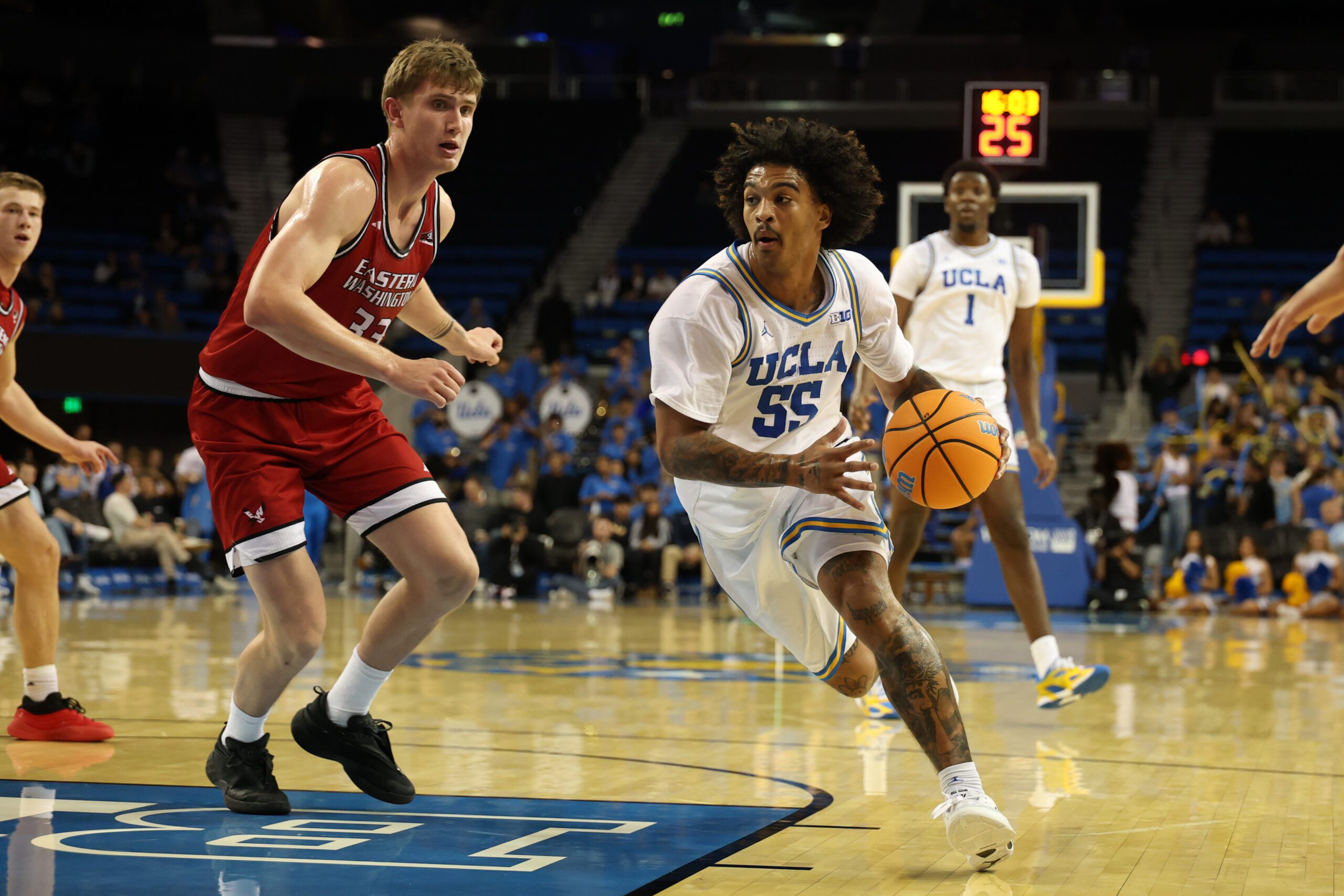Nov 3, 2025; Los Angeles, California, USA;  UCLA Bruins guard Skyy Clark (55) drives to the basket against Eastern Washington Eagles forward Emmett Marquardt (33) during the second half at Pauley Pavilion presented by Wescom Financial. Mandatory Credit: Kiyoshi Mio-Imagn Images