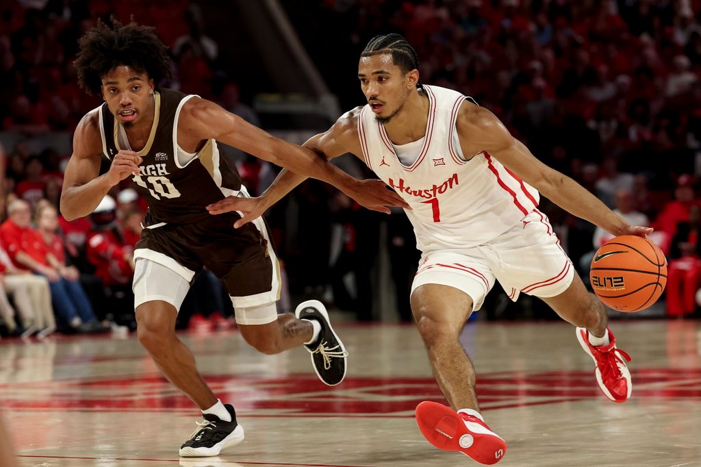 Nov 3, 2025; Houston, Texas, USA; Houston Cougars guard Milos Uzan (7) drives against Lehigh Mountain Hawks guard Caleb Thomas (10) during the first half at Fertitta Center. Mandatory Credit: Maria Lysaker-Imagn Images