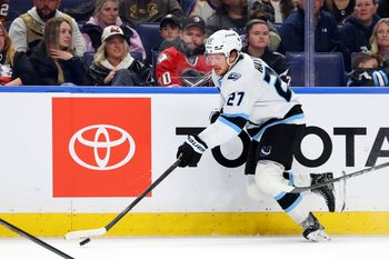 Nov 4, 2025; Buffalo, New York, USA;  Utah Mammoth center Barrett Hayton (27) skates up ice with the puck during the third period against the Buffalo Sabres at KeyBank Center. Mandatory Credit: Timothy T. Ludwig-Imagn Images