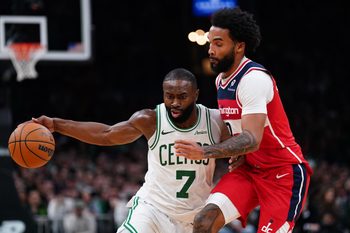 Nov 5, 2025; Boston, Massachusetts, USA; Boston Celtics guard/forward Jaylen Brown (7) drives the ball against Washington Wizards guard/forward Justin Champagnie (9)  in the second half at TD Garden. Mandatory Credit: David Butler II-Imagn Images