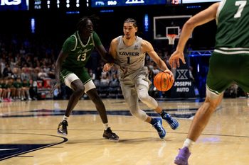 Xavier Musketeers guard Malik Messina-Moore (1) drives on Le Moyne Dolphins guard Deng Garang (13) in the second half of the NCAA game at the Cintas Center in Cincinnati on Nov. 6, 2025.
