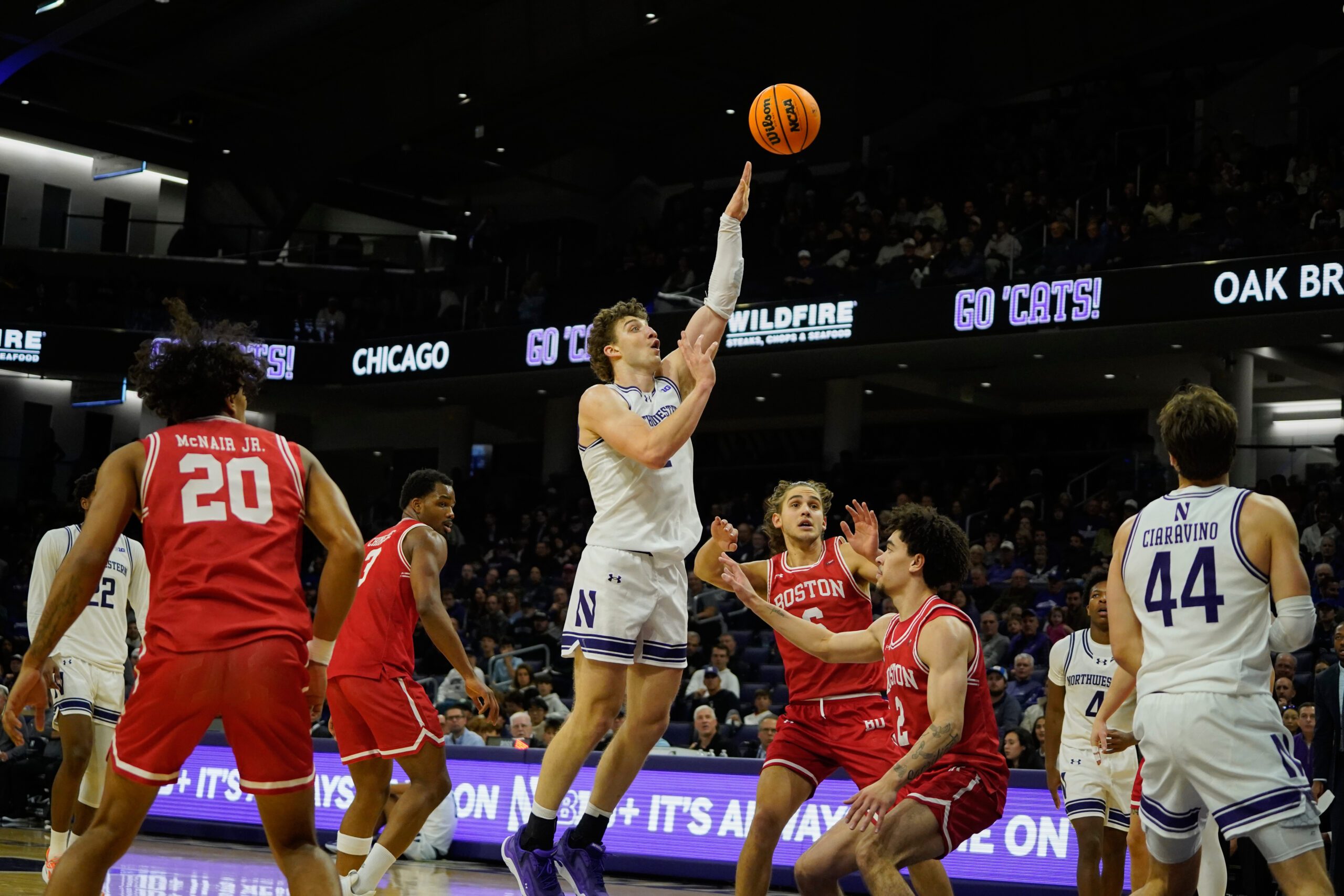 Nov 7, 2025; Evanston, Illinois, USA; Northwestern Wildcats forward Nick Martinelli (2) shoots the ball against Boston University Terriers guard Chance Gladden (2) during the first half at Welsh-Ryan Arena. Mandatory Credit: David Banks-Imagn Images
