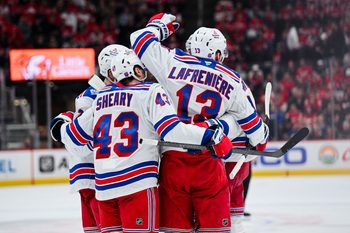 Nov 7, 2025; Detroit, Michigan, USA; New York Rangers left wing Alexis Lafrenière (13) celebrates his goal with teammates during the third period against the Detroit Red Wings at Little Caesars Arena. Mandatory Credit: Tim Fuller-Imagn Images