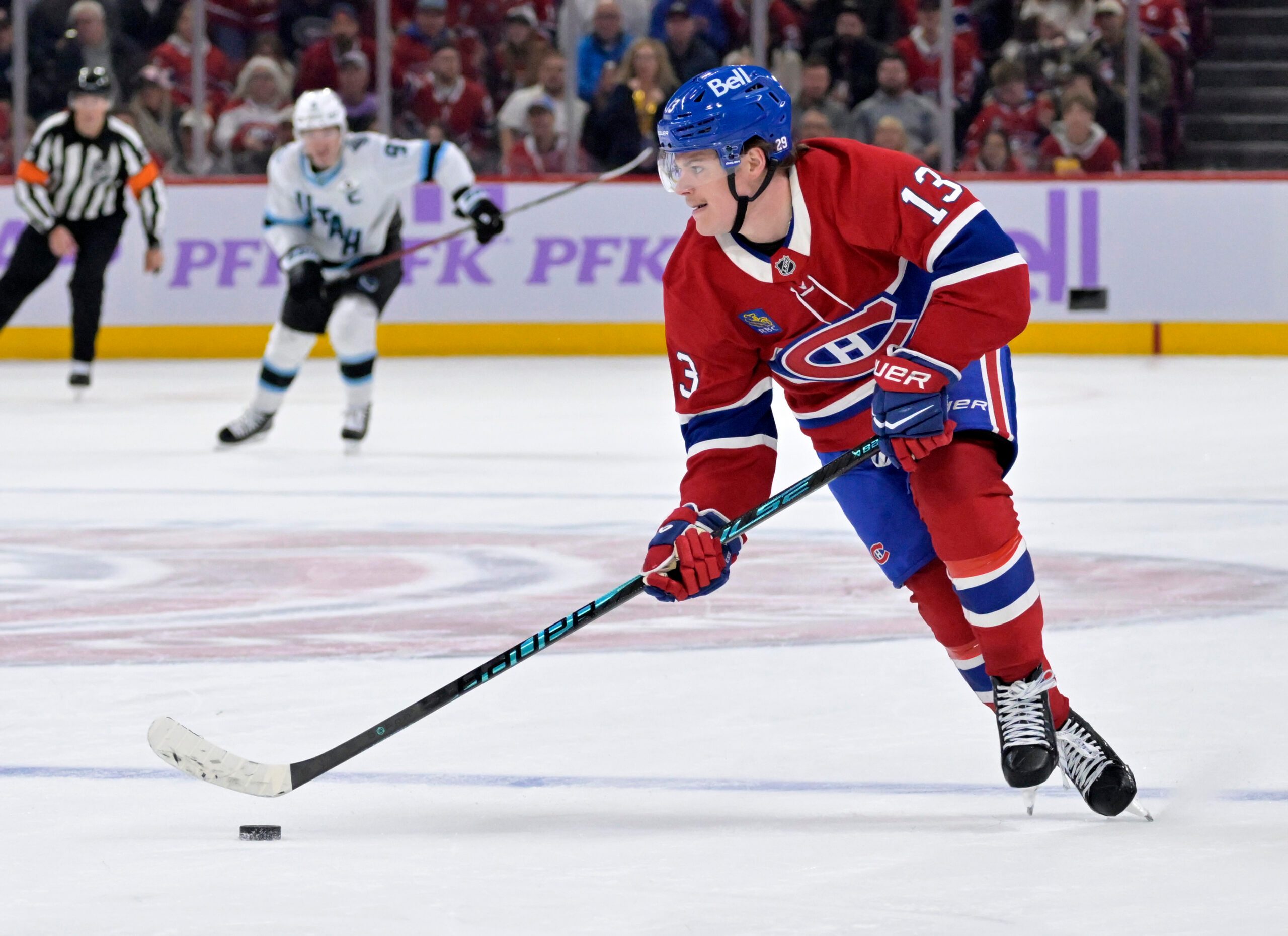 Nov 8, 2025; Montreal, Quebec, CAN; Montreal Canadiens forward Cole Caufield (13) plays the puck against the Utah Mammoth during the third period at the Bell Centre. Mandatory Credit: Eric Bolte-Imagn Images