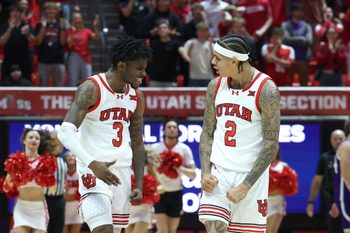Nov 8, 2025; Salt Lake City, Utah, USA; Utah Utes guard Don McHenry (left) reacts to making a three point basket with guard Terrence Brown (right) that tied the game with five seconds left in the game against the Weber State Wildcats at Jon M. Huntsman Center. Mandatory Credit: Rob Gray-Imagn Images