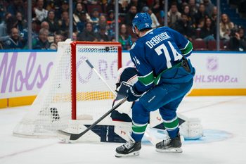 Nov 8, 2025; Vancouver, British Columbia, CAN; Vancouver Canucks forward Jake DeBrusk (74) scores on Columbus Blue Jackets goalie Elvis Merzlikins (90) in the second period at Rogers Arena. Mandatory Credit: Bob Frid-Imagn Images