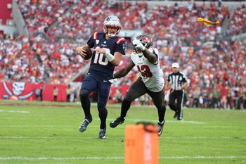 Nov 9, 2025; Tampa, Florida, USA; New England Patriots quarterback Drake Maye (10) runs for a gain past Tampa Bay Buccaneers safety Tykee Smith (23) during the fourth quarter at Raymond James Stadium. Mandatory Credit: Nathan Ray Seebeck-Imagn Images