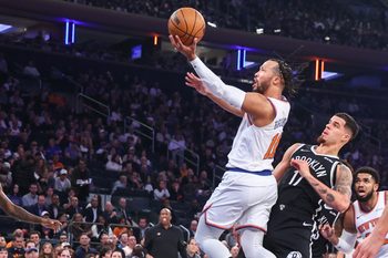 Nov 9, 2025; New York, New York, USA;  New York Knicks guard Jalen Brunson (11) drives past Brooklyn Nets forward Michael Porter Jr. (17) in the first quarter at Madison Square Garden. Mandatory Credit: Wendell Cruz-Imagn Images