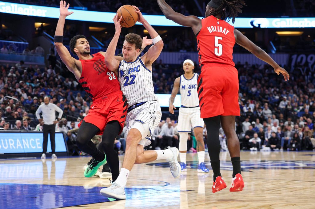 Nov 10, 2025; Orlando, Florida, USA; Orlando Magic forward Franz Wagner (22) drives to the basket past Portland Trail Blazers forward Toumani Camara (33) in the fourth quarter at Kia Center. Mandatory Credit: Nathan Ray Seebeck-Imagn Images