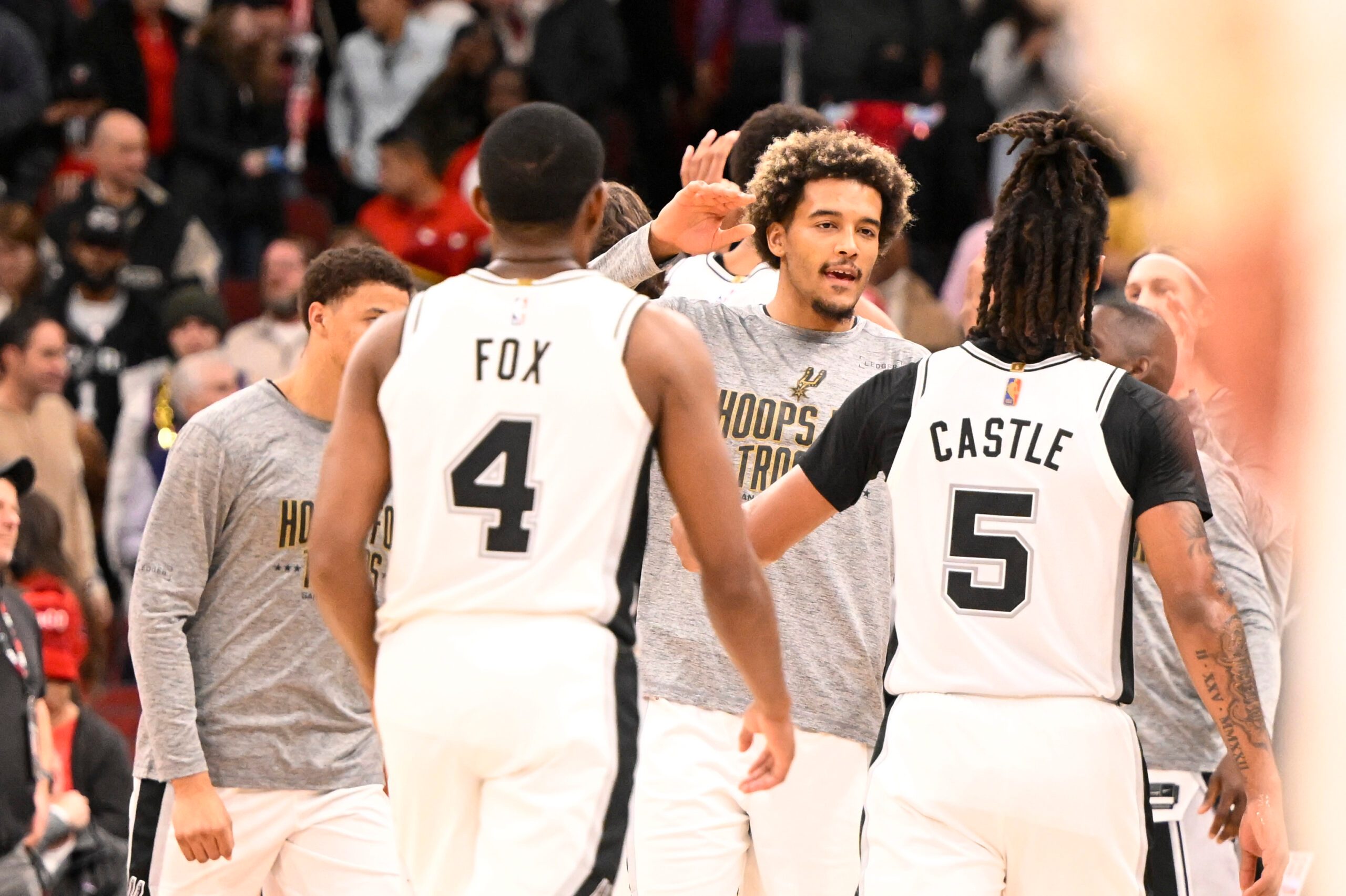Nov 10, 2025; Chicago, Illinois, USA; San Antonio Spurs teammates celebrate against the Chicago Bulls during the second half at the United Center. Mandatory Credit: Matt Marton-Imagn Images