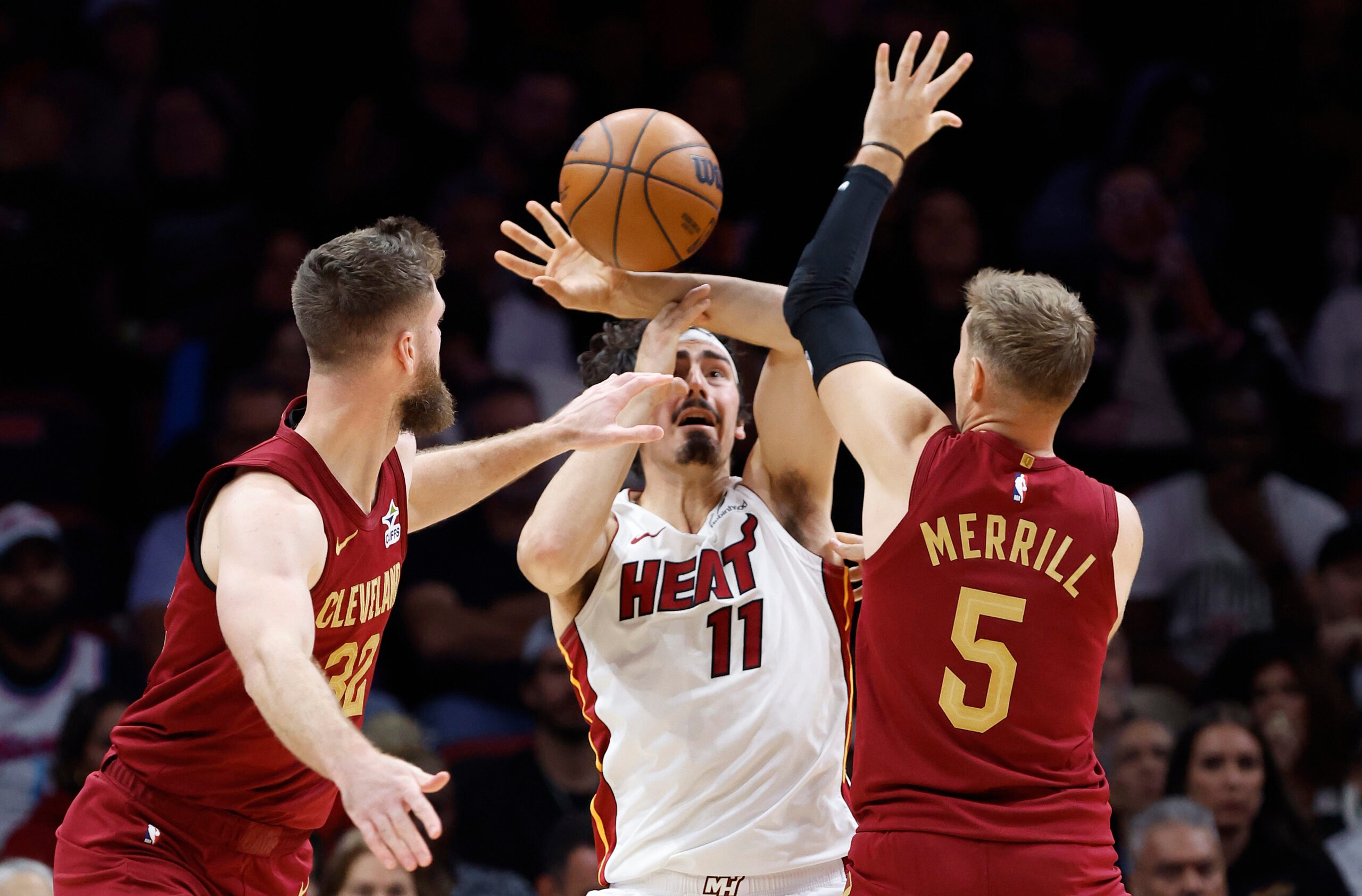 Nov 10, 2025; Miami, Florida, USA;  Cleveland Cavaliers forward Dean Wade (32) and guard Sam Merrill (5) defend Miami Heat forward Jaime Jaquez Jr. (11) during the second half at Kaseya Center. Mandatory Credit: Rhona Wise-Imagn Images