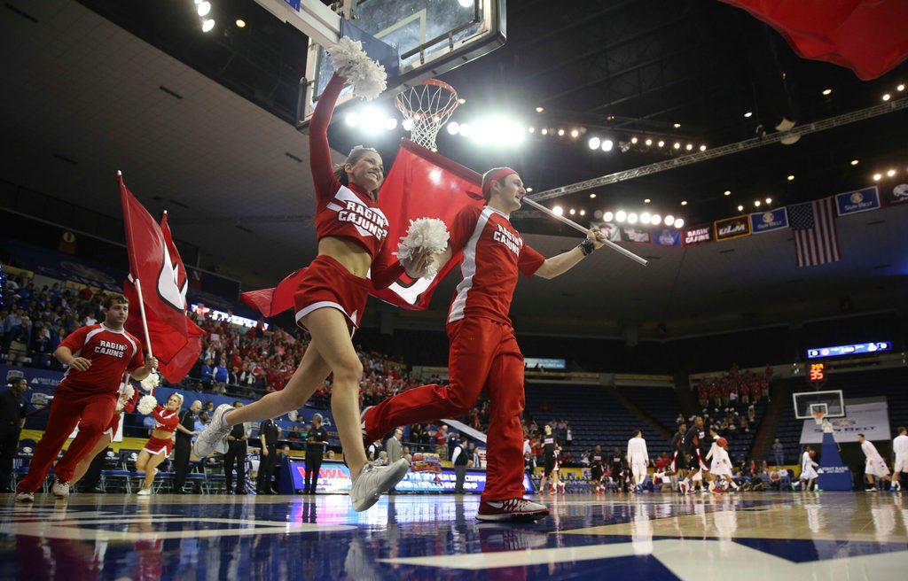 Mar 16, 2014; New Orleans, LA, USA; Louisiana Lafayette Ragin Cajuns cheerleaders lead the team onto the court prior to tipoff against the Georgia State Panthers in the championship game of the Sun Belt Conference college basketball tournament at Lakefront Arena. Louisiana Lafayette defeated Georgia State 82-81. Mandatory Credit: Crystal LoGiudice-Imagn Images