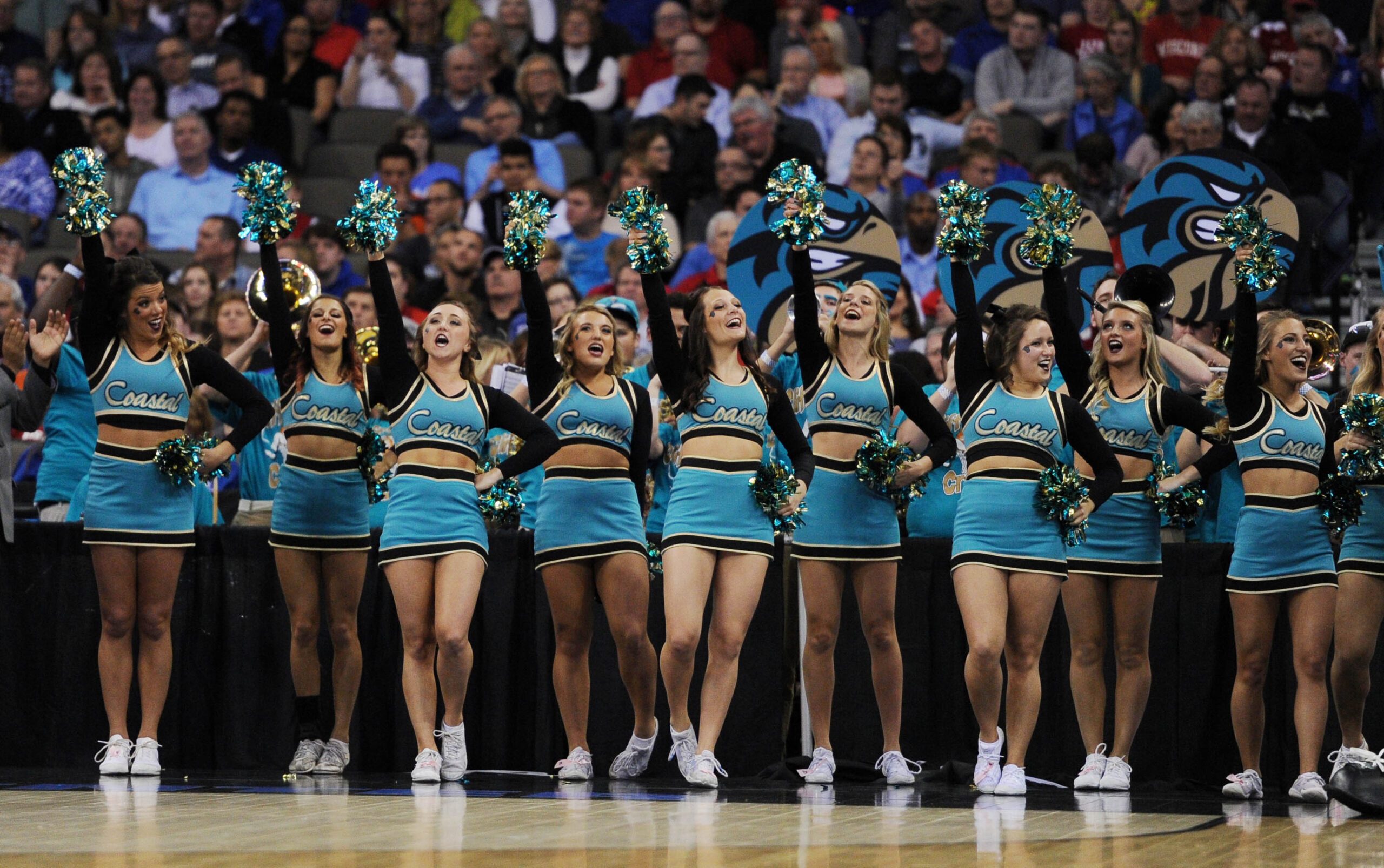 Mar 20, 2015; Omaha, NE, USA; Coastal Carolina Chanticleers cheerleaders perform against the Wisconsin Badgers during the first half in the second round of the 2015 NCAA Tournament at CenturyLink Center. Mandatory Credit: Steven Branscombe-Imagn Images