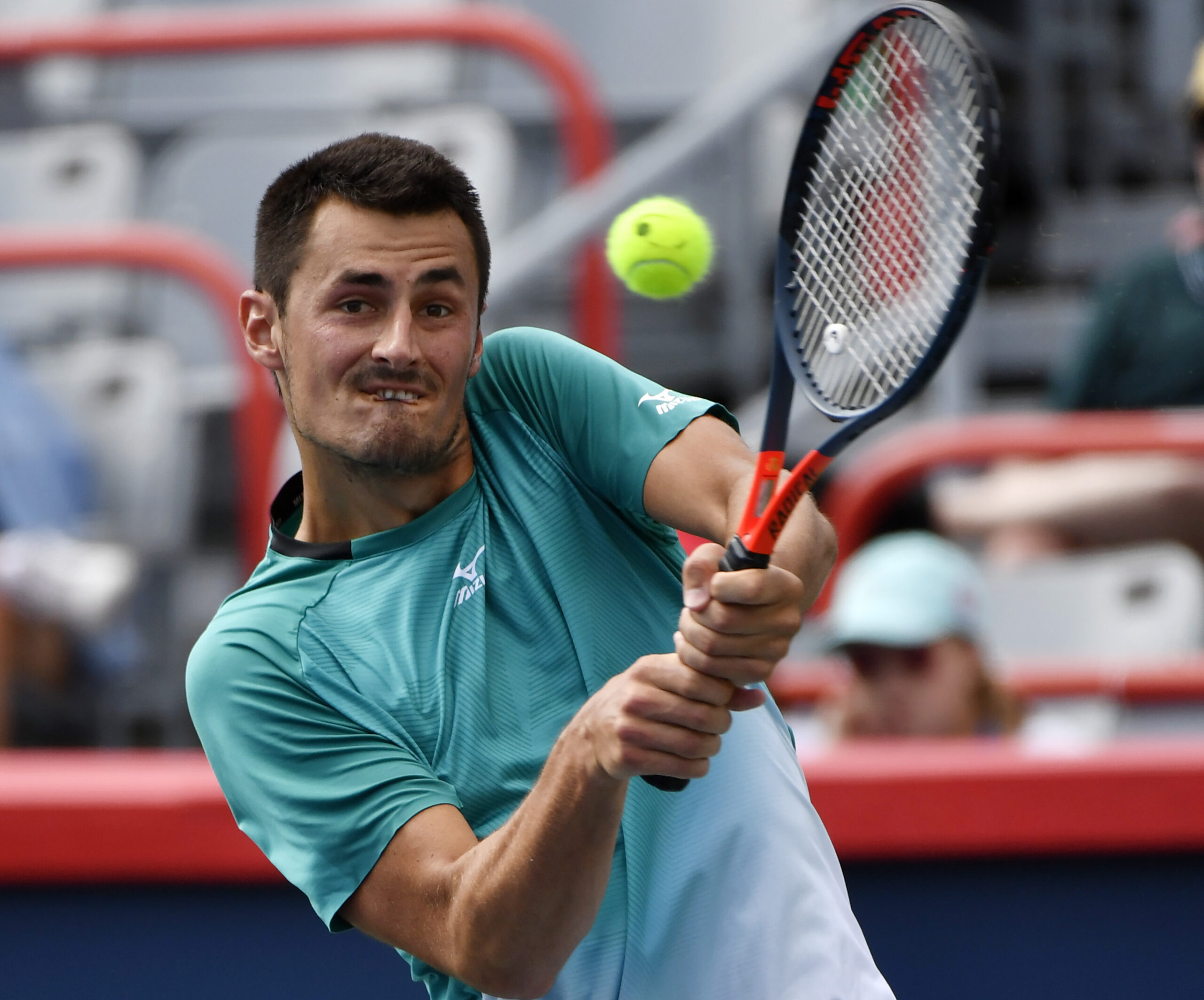 Aug 4, 2019; Montreal, Quebec, Canada; Bernard Tomic of Australia plays a shot against Marc Polmans of Australia (not pictured) during the Rogers Cup tennis tournament at Stade IGA. Mandatory Credit: Eric Bolte-Imagn Images