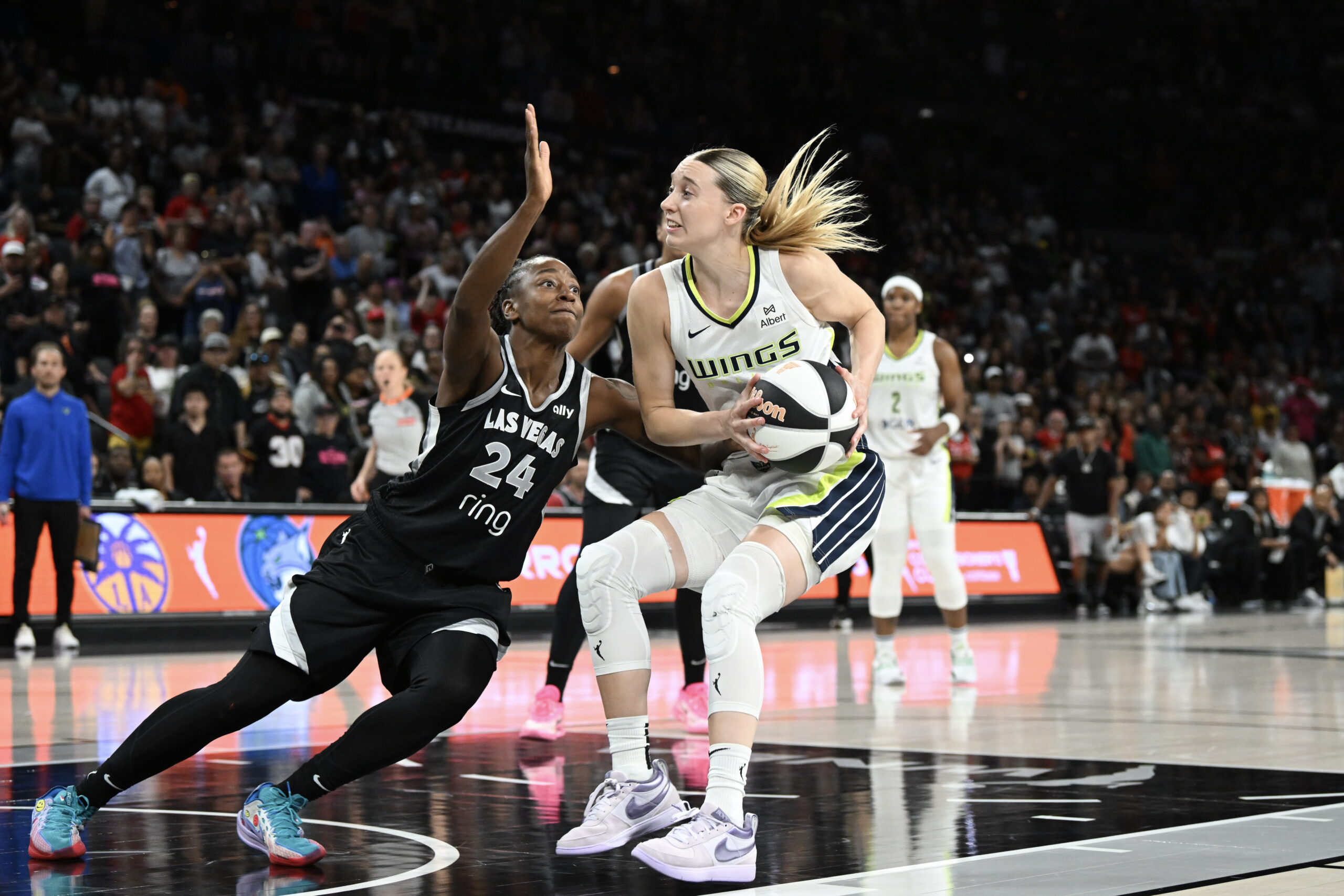 Jun 13, 2025; Las Vegas, Nevada, USA; Las Vegas Aces guard Jewell Loyd (24) collides wth Dallas Wings guard Paige Bueckers (5) in the fourth quarter of their game at Michelob Ultra Arena. Mandatory Credit: Candice Ward-Imagn Images
