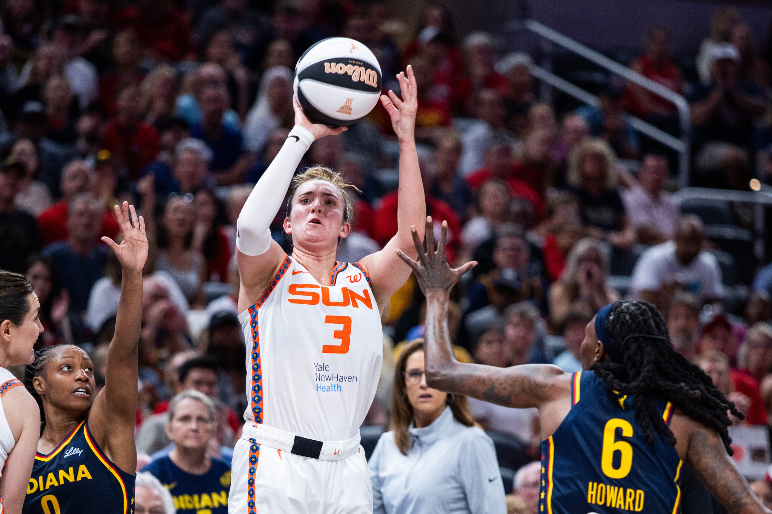 Jun 17, 2025; Indianapolis, Indiana, USA; Connecticut Sun guard Marina Mabrey (3) shoots the ball while Indiana Fever forward Natasha Howard (6) defends in the second half at Gainbridge Fieldhouse. Mandatory Credit: Trevor Ruszkowski-Imagn Images