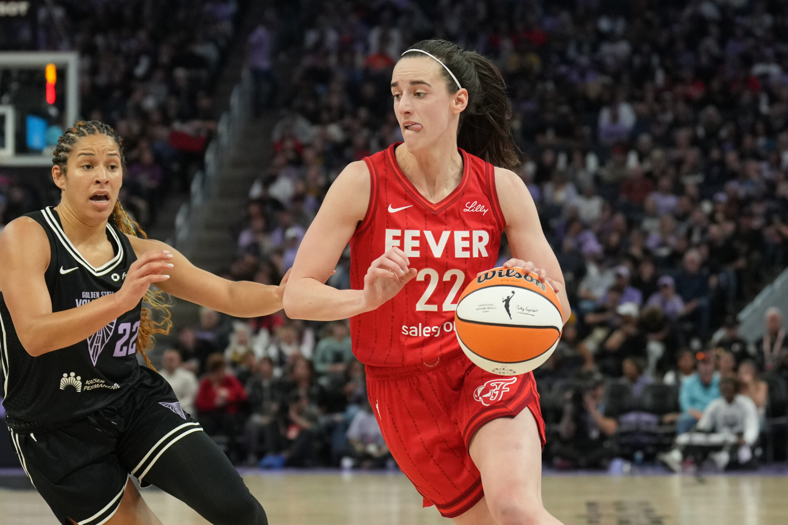 Jun 19, 2025; San Francisco, California, USA; Indiana Fever guard Caitlin Clark (center) dribbles against Golden State Valkyries guard Veronica Burton (left) during the third quarter at Chase Center. Mandatory Credit: Darren Yamashita-Imagn Images