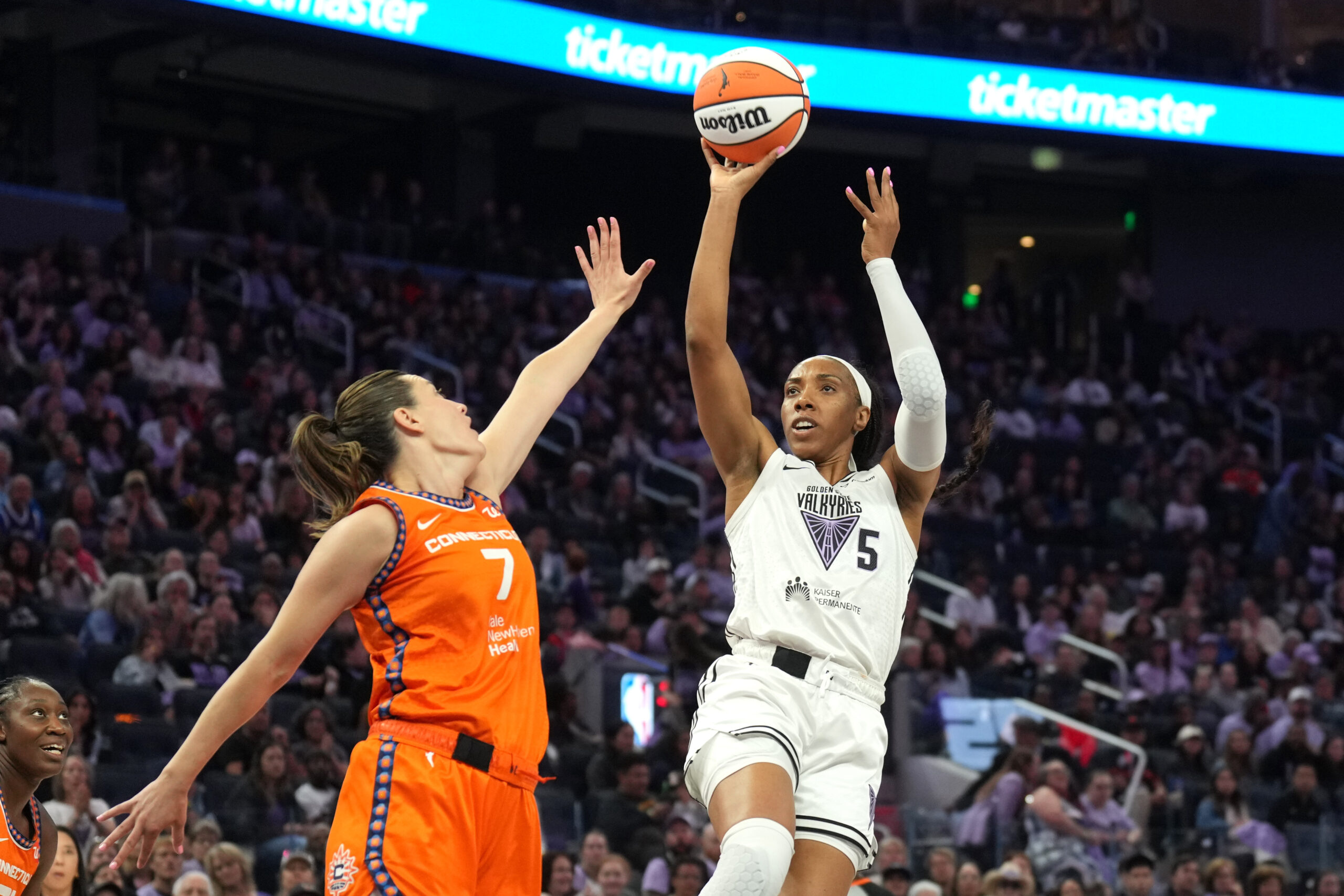 Jun 22, 2025; San Francisco, California, USA; Golden State Valkyries forward Kayla Thornton (5) shoots against Connecticut Sun forward Haley Peters (7) during the second quarter at Chase Center. Mandatory Credit: Darren Yamashita-Imagn Images