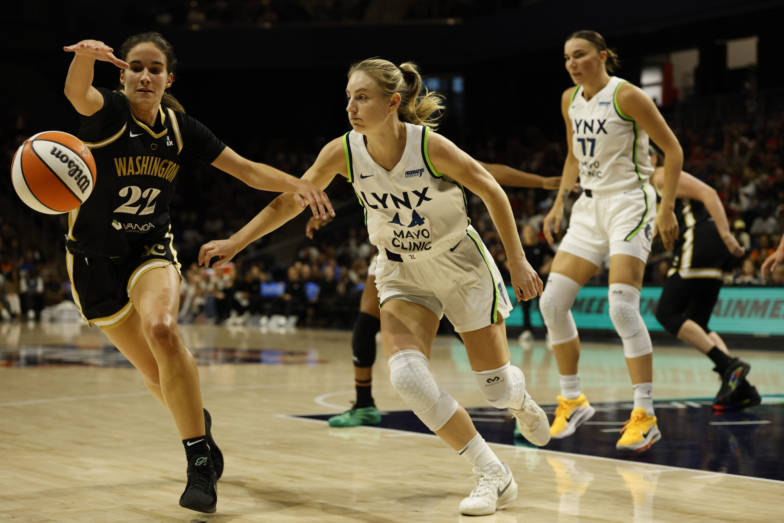 Jun 24, 2025; Washington, District of Columbia, USA; Washington Mystics guard Sonia Citron (22) and Minnesota Lynx guard Karlie Samuelson (44) chase a loose ball in the first half at Entertainment & Sports Arena. Mandatory Credit: Geoff Burke-Imagn Images