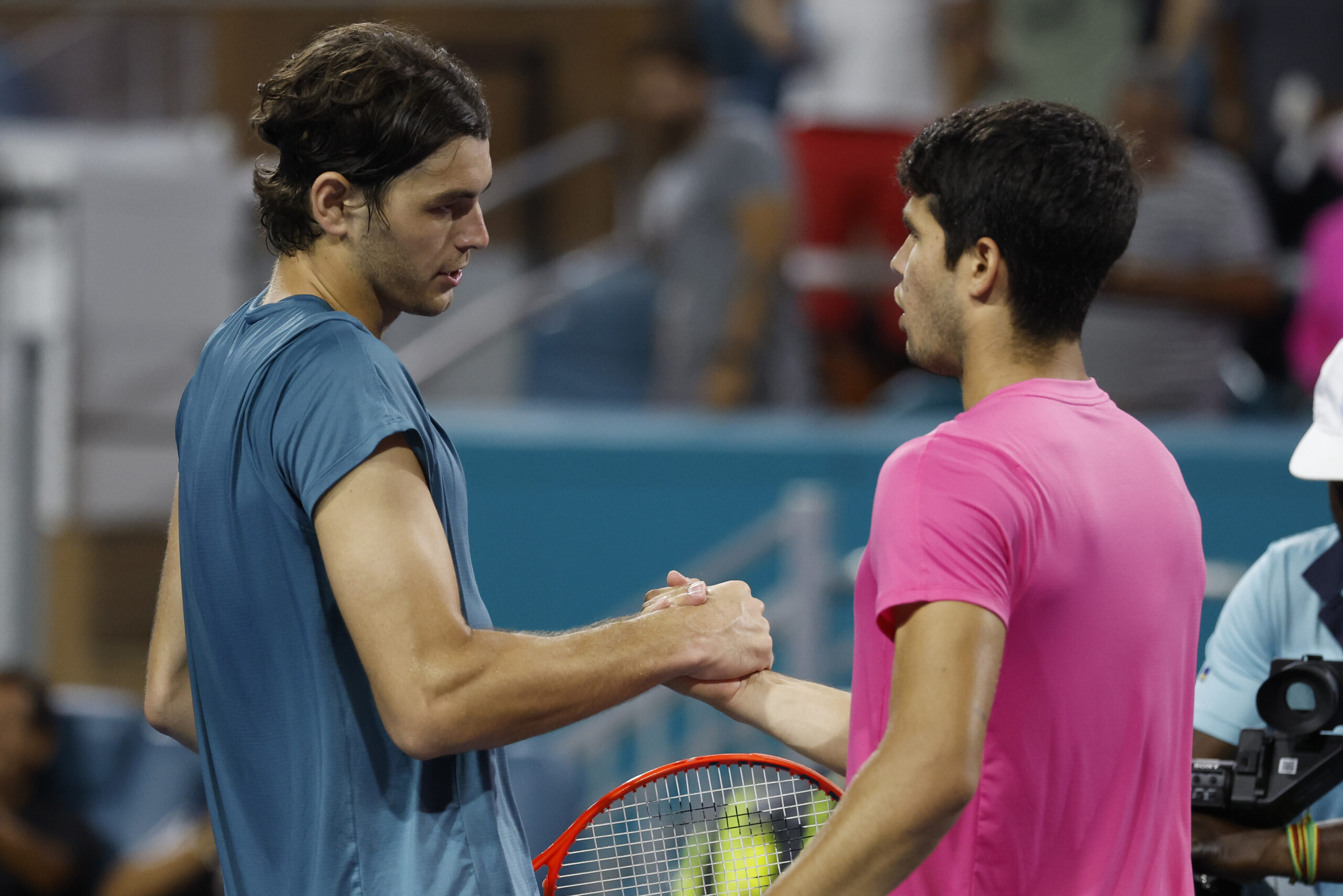 Mar 30, 2023; Miami, Florida, US; Carlos Alcaraz (ESP) (R) shakes hands with Taylor Fritz (USA) (L) after their men's singles quarterfinal on day eleven of the Miami Open at Hard Rock Stadium. Mandatory Credit: Geoff Burke-Imagn Images