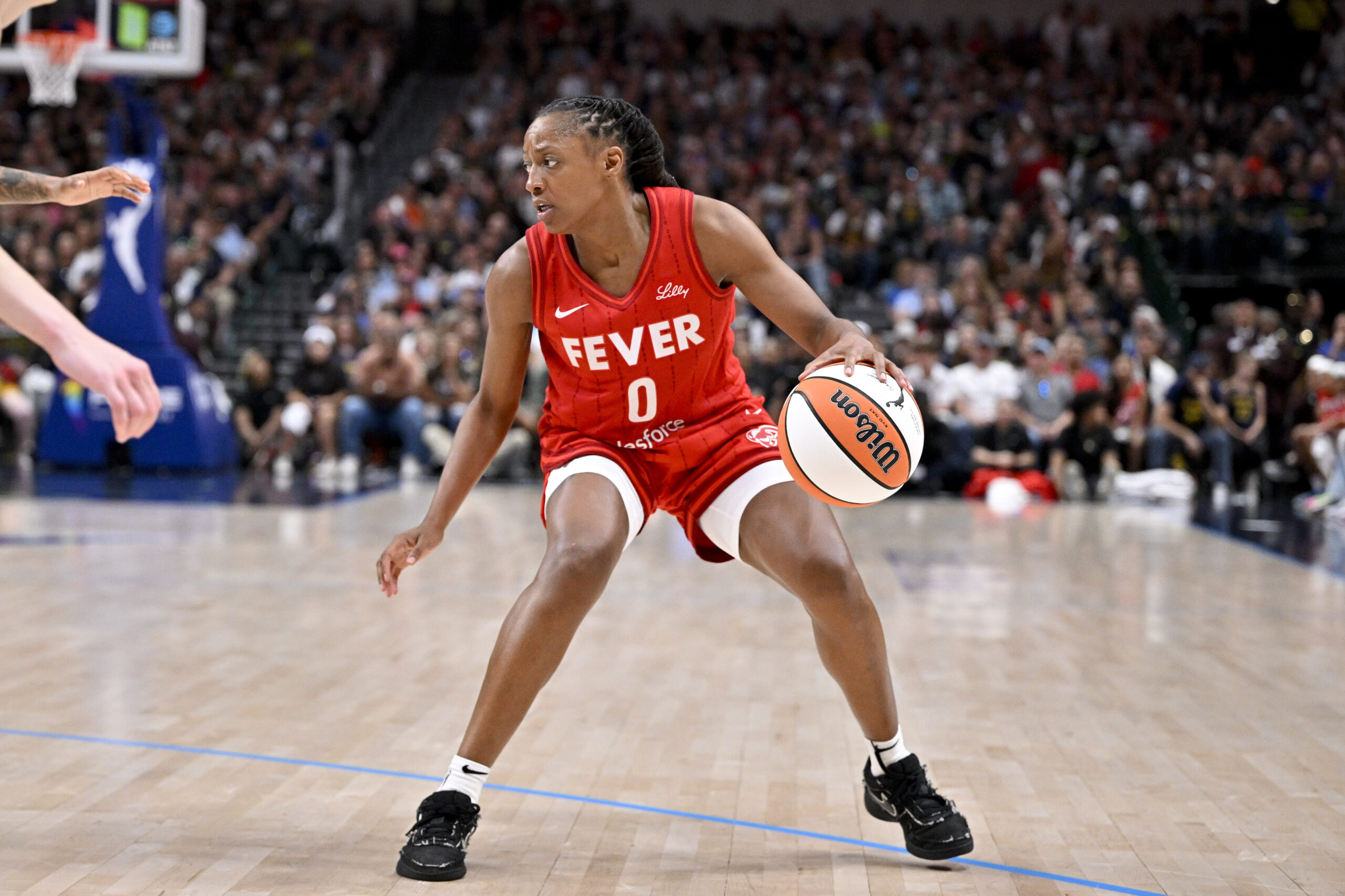 Jun 27, 2025; Dallas, Texas, USA; Indiana Fever guard Kelsey Mitchell (0) brings the ball up court against the Dallas Wings during the second half at the American Airlines Center. Mandatory Credit: Jerome Miron-Imagn Images
