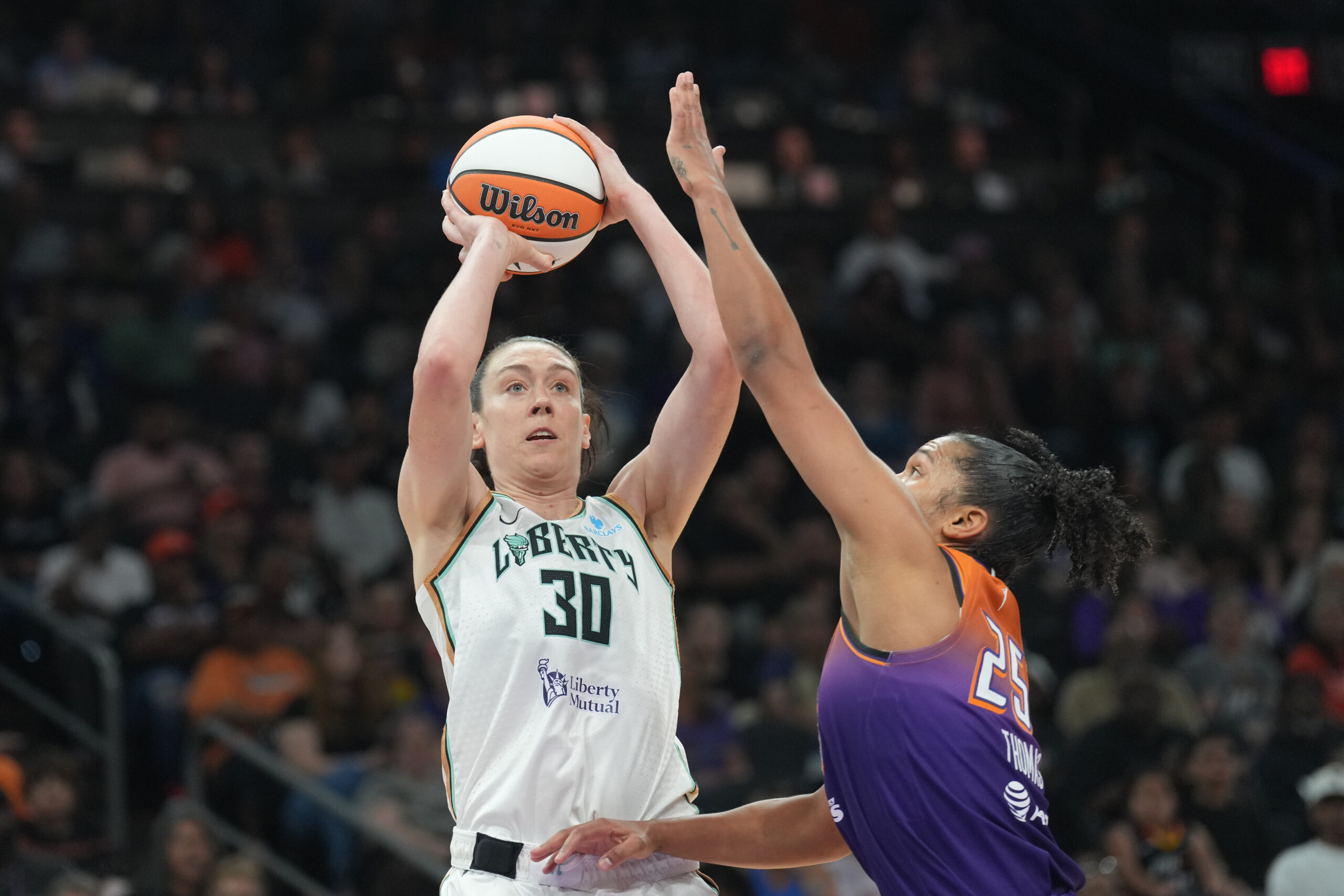 Jun 27, 2025; Phoenix, Arizona, USA; New York Liberty forward Breanna Stewart (30) shoots over Phoenix Mercury forward Alyssa Thomas (25) during the second half at Footprint Center. Mandatory Credit: Joe Camporeale-Imagn Images