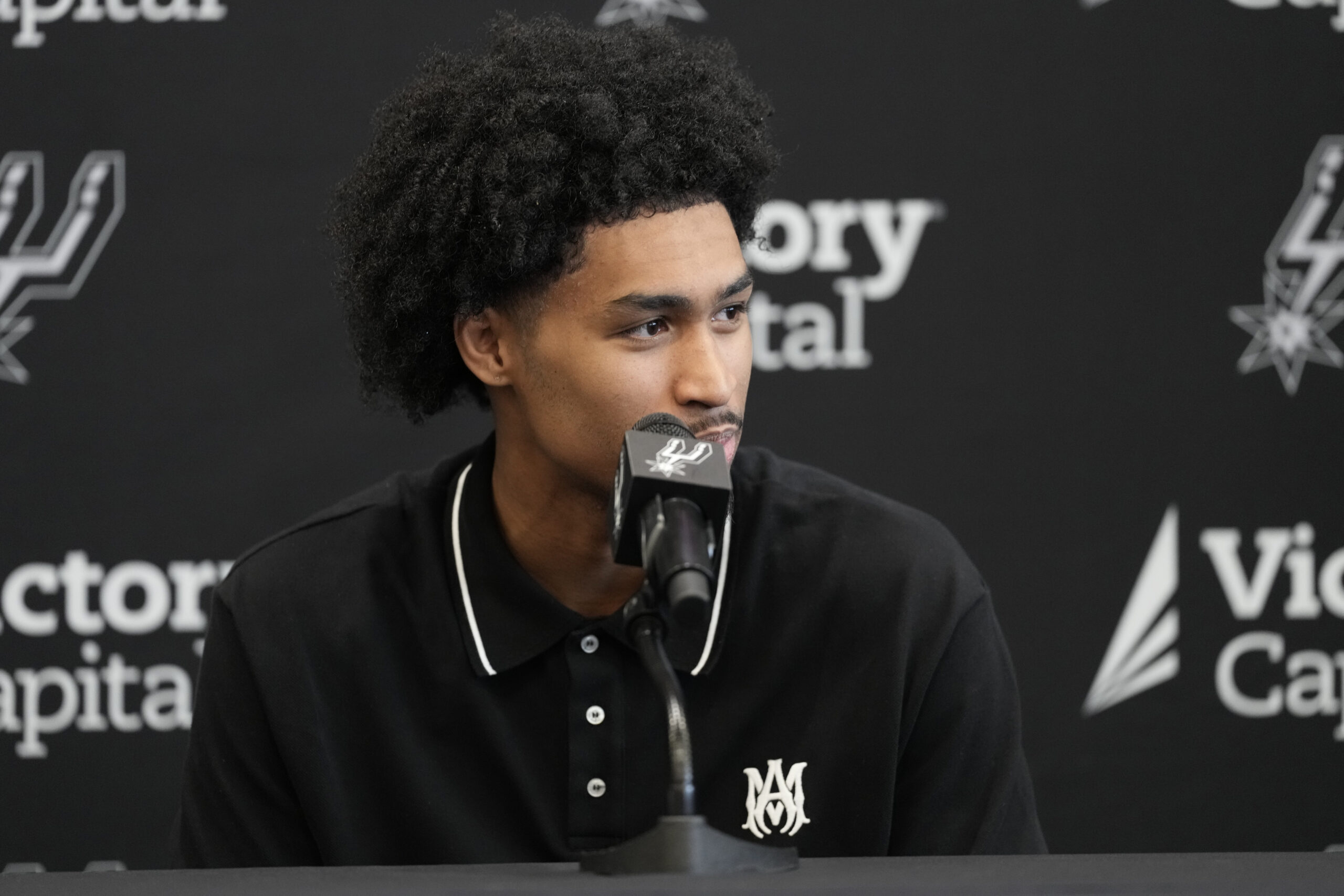 Jun 28, 2025; San Antonio, TX, USA; San Antonio Spurs first round draft pick Dylan Harper answers questions during press conference at Victory Capital Performance Center. Mandatory Credit: Scott Wachter-Imagn Images