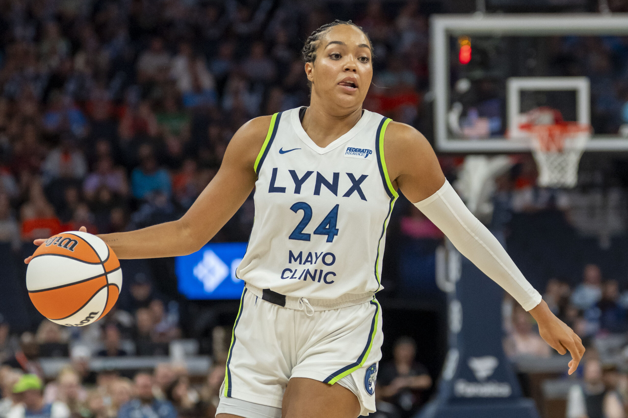 Jun 29, 2025; Minneapolis, Minnesota, USA; Minnesota Lynx forward Napheesa Collier (24) dribbles the ball against the Connecticut Sun in the first half at Target Center. Mandatory Credit: Jesse Johnson-Imagn Images