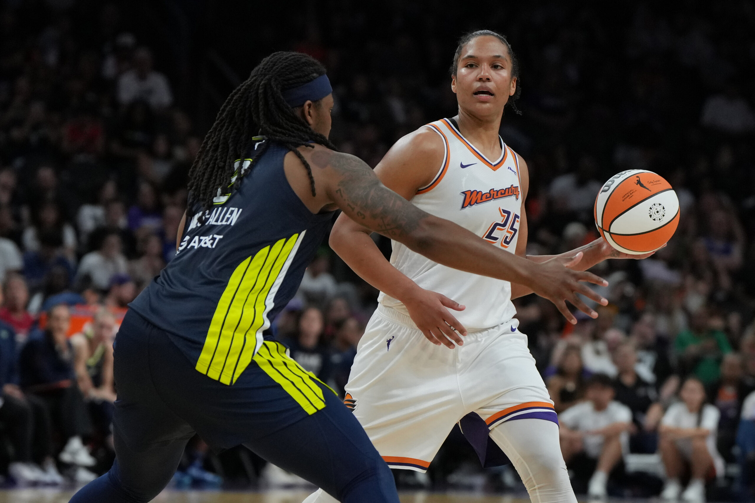 Jul 7, 2025; Phoenix, Arizona, USA; Phoenix Mercury forward Alyssa Thomas (25) looks to pass around Dallas Wings forward Myisha Hines-Allen (2) in the second half at Footprint Center. Mandatory Credit: Rick Scuteri-Imagn Images