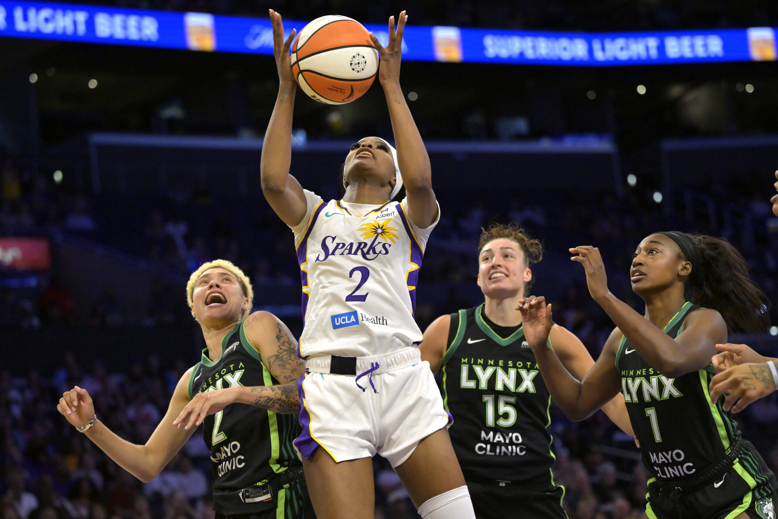 Jul 10, 2025; Los Angeles, California, USA; Los Angeles Sparks forward Rickea Jackson (2) rebounds in front of Minnesota Lynx guard Natisha Hiedeman (2), forward Jessica Shepard (15) and forward Diamond Miller (1) in the second half at Crypto.com Arena. Mandatory Credit: Jayne Kamin-Oncea-Imagn Images