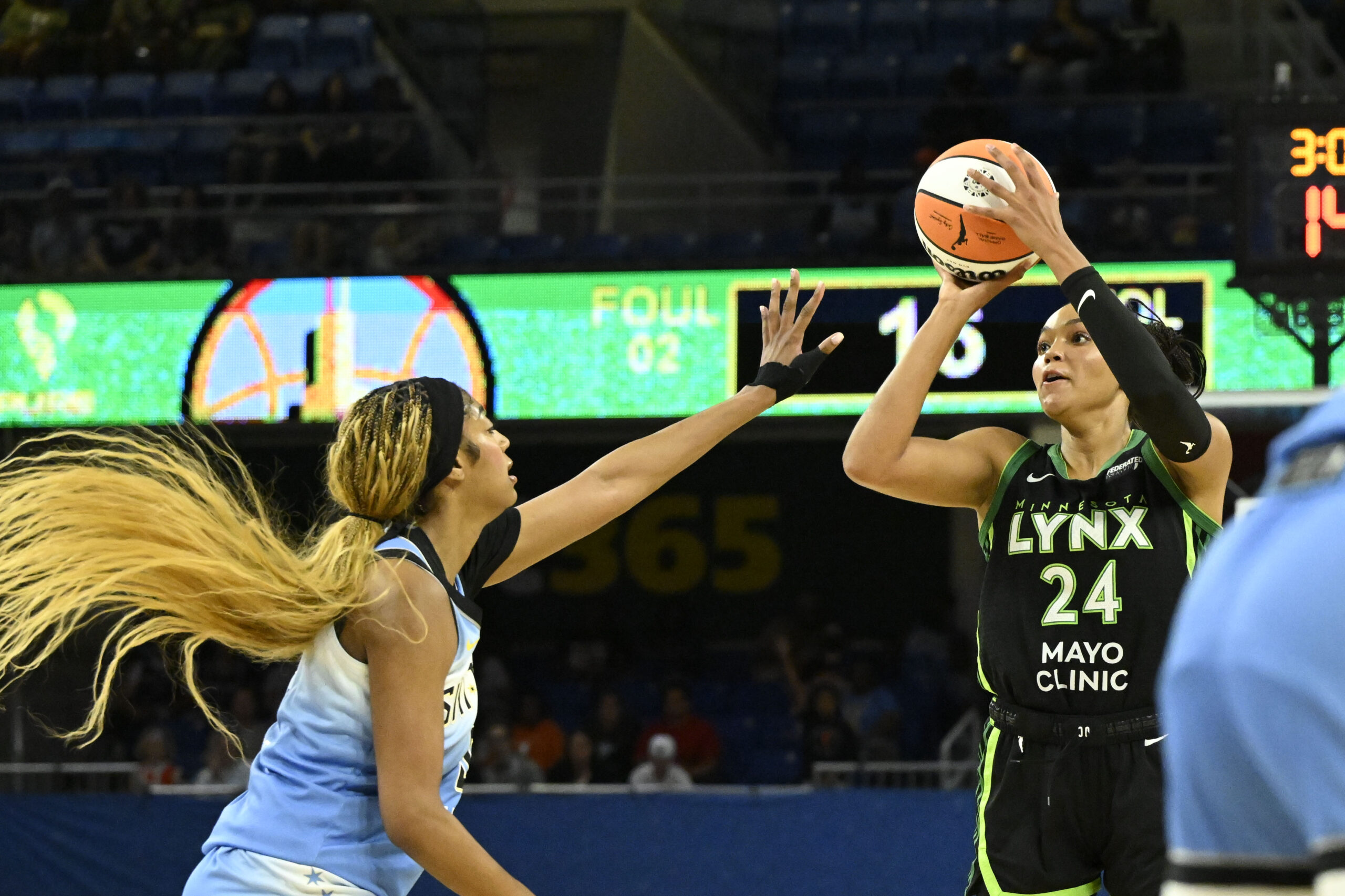 Jul 14, 2025; Chicago, Illinois, USA; Minnesota Lynx forward Napheesa Collier (24) passes the ball against Chicago Sky forward Angel Reese (5) during the first half at Wintrust Arena. Mandatory Credit: Matt Marton-Imagn Images