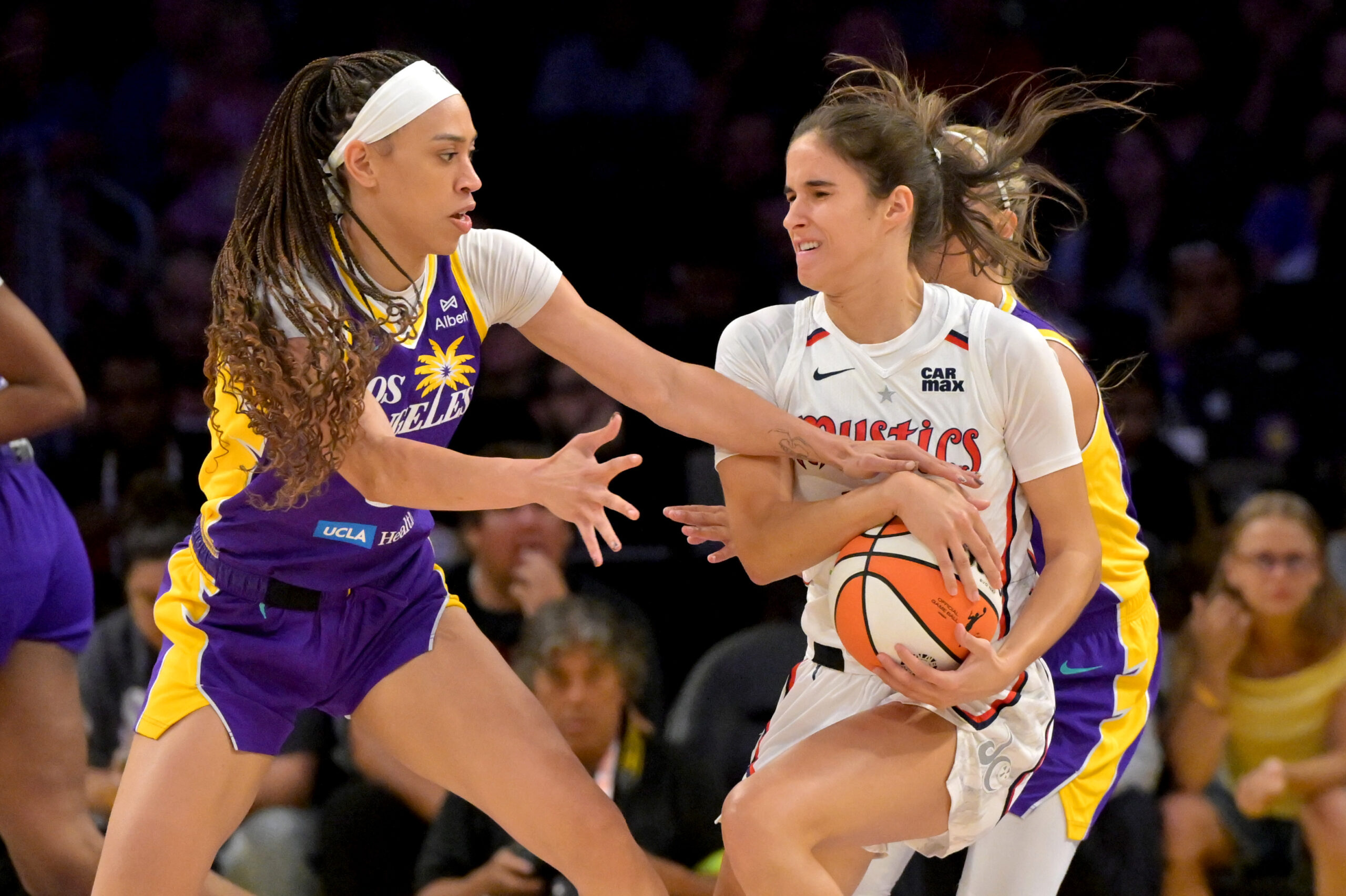 Jul 15, 2025; Los Angeles, California, USA; Los Angeles Los Angeles Sparks forward Dearica Hamby (5) reaches in for the ball controlled by Washington Mystics forward Emily Engstler (21) during the first half at Crypto.com Arena. Mandatory Credit: Jayne Kamin-Oncea-Imagn Images